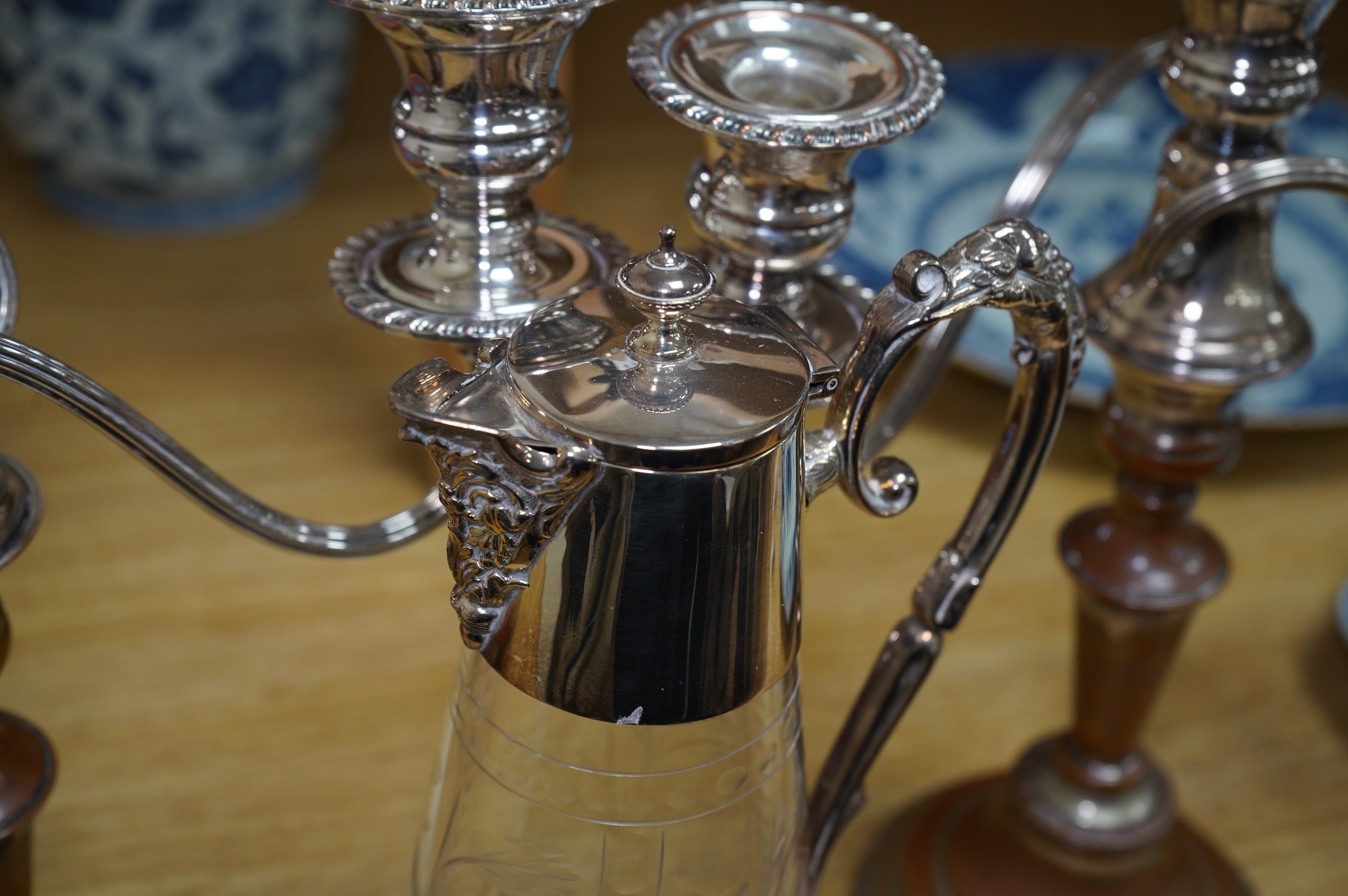 A Victorian silver plated claret jug, together with a pair of candelabra, 30cm. Condition - worn